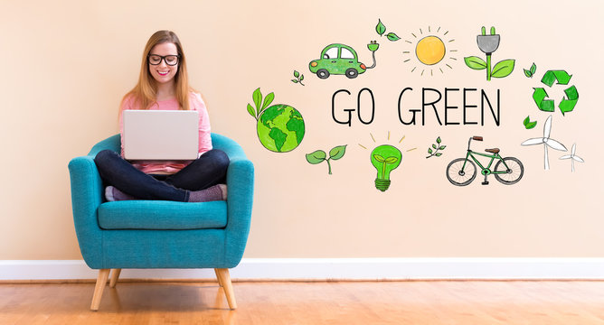 Go Green with young woman using her laptop in a chair