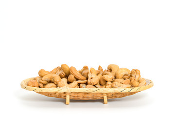 Roasted cashew nuts in basket on white background