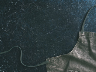 denim cotton apron on dark background, copy space