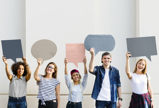 Young adult friends holding up copyspace placard thought bubbles