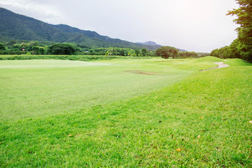 Golf course with nature at sky.