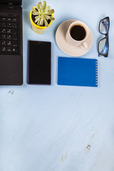 Laptop, glasses, coffee and plant