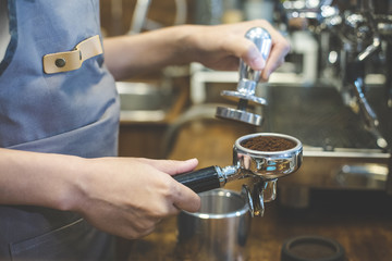 Hand of Barista made coffee at cafe. Barista prepare coffee to customer. Vintage tone.