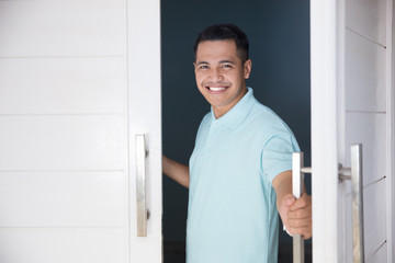  man open his front house door and smiling