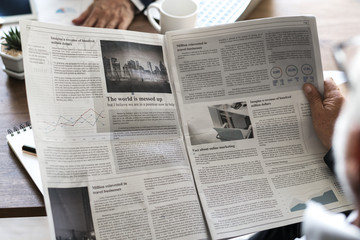 Business people reading newspaper - Powered by Adobe