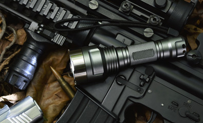 Tactical flash light and assault rifle gun weapon. LED Pocket flashlight.