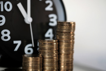 Step of coins stacks and alarm clock with tablet computer and financial graph, business planning vision and finance analysis concept.