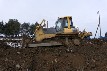 An excavator working removing earth on a construction site.