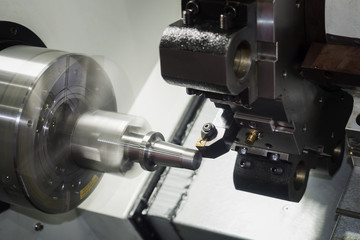 Fototapeta na wymiar machining automotive part by cnc turning machine