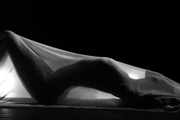 sensual sexy look of beautiful figure girl under hiding in light thin fabric, to show silhouette of...
