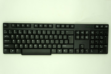 Office desk table with keyboard black with hand Top view on white background .