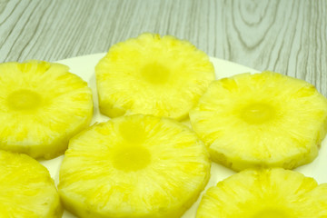 Naklejka na ściany i meble Close-up of juicy yellow pineapple slices .