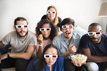 Obraz premium Group of diverse friends watching 3D movie together