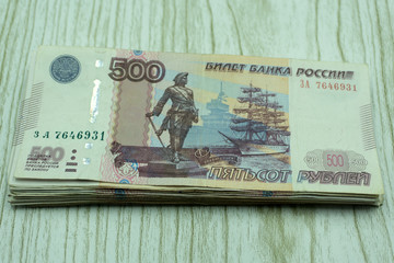 A stack of money in denominations of 500 rubles .