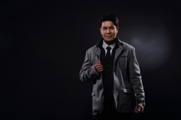 Portrait half body, Business Man Stand in gray coat white shirt black pants, studio