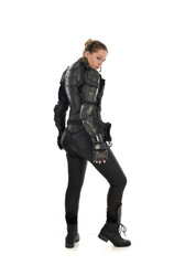 full length portrait of female  soldier wearing black  tactical armour  facing away from camera,...