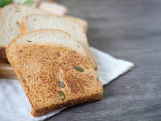 Sliced cereal bread on wood worktop, copy space for healthy issue
