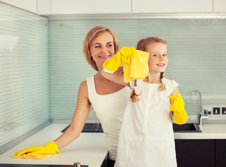 Mother with child washing kitchen