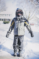 Fototapeta na wymiar Boy bundled for the cold outdoors in winter, shallow focus on coat