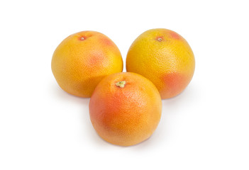 Three red grapefruits on a white background