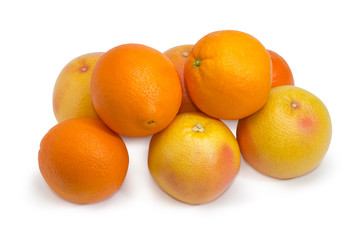 Several red grapefruits and oranges on a white background