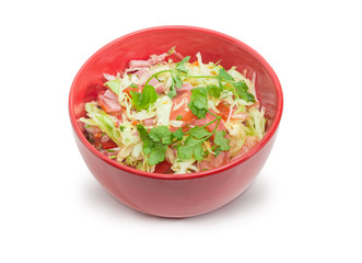 Vegetable salad with ham in the red bowl