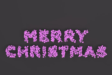 Merry Christmas words from violet balls on black background