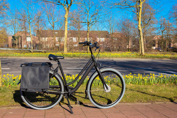 Fototapeta premium The bicycle stands on a bicycle path near the highway.