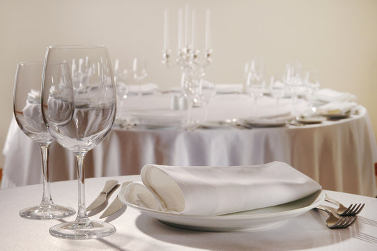 Served table in the restaurant - clean glasses, plates, forks, napkin