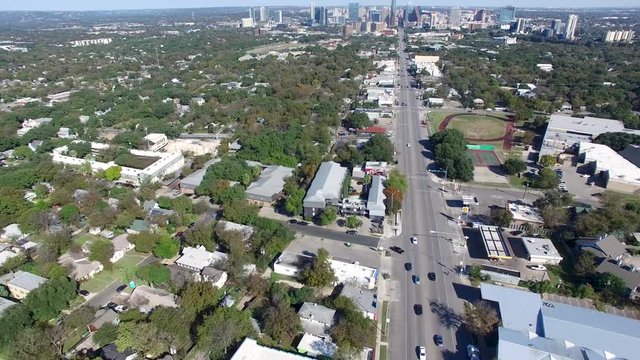 Slow aerial view of cars driving on South Congress Avenue in Austin, Texas.