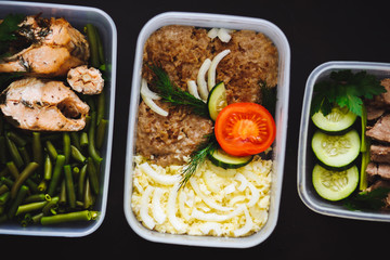 Close up of healthy food in three containers on black background
