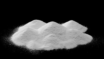 Pile of coconut flour, powder isolated on black background