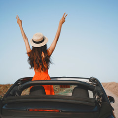 Happy woman in car cabriolet