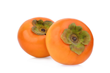 two whole ripe persimmons isolated on white background