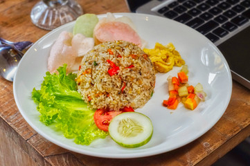 salted fish fried rice with a complement of crackers, omelet, pickled cucumber, and lettuce