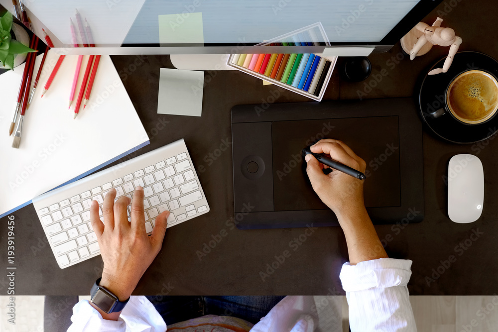 Poster top view designer working with digital tablet and desktop computer at dark desk