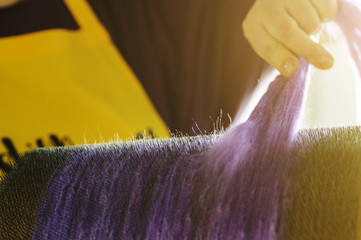 Felting wool. Combing the wool of alpaca or llama before felting on a special machine with a drum...