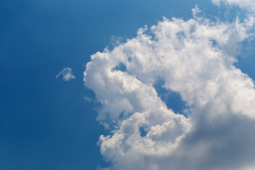 White fluffy clouds in the blue sky background