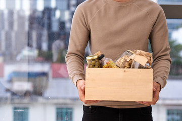 Volunteer with box of food for poor. Donation concept.