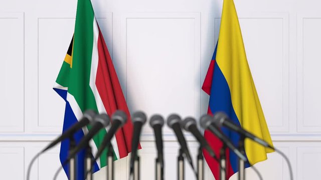 Flags of South Africa and Colombia at international meeting or negotiations press conference
