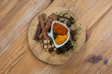 Various spices and herbs on wooden table