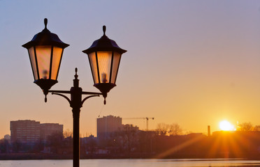 Street lamp at dawn. Street lighting in the sunset.