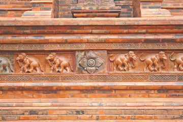 Flower and elephant patterns statue on pagoda on background