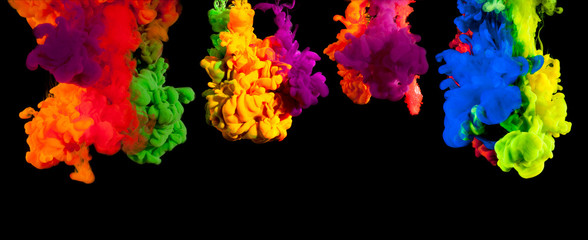 Color paint injected in water on a black background
