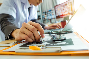 Medical technology concept. Doctor working with smart phone and stethoscope and digital tablet computer in modern office at hospital in morning light
