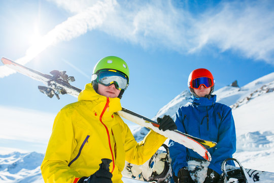 Image of sports men with skis and snowboard in winter