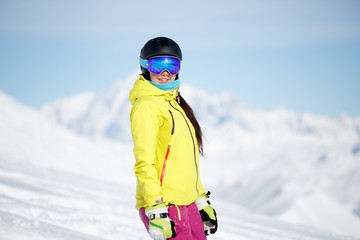 Fototapeta na wymiar Portrait of sports girl in helmet on mountainside