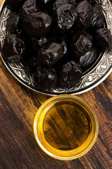 Close up of black olives and olive oil
