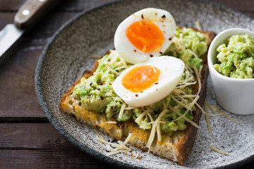 Toast with mashed avocado, egg and cheese