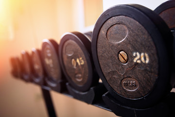 Fototapeta na wymiar Dumbells on the racks at the gym,exercise and relaxing concept.